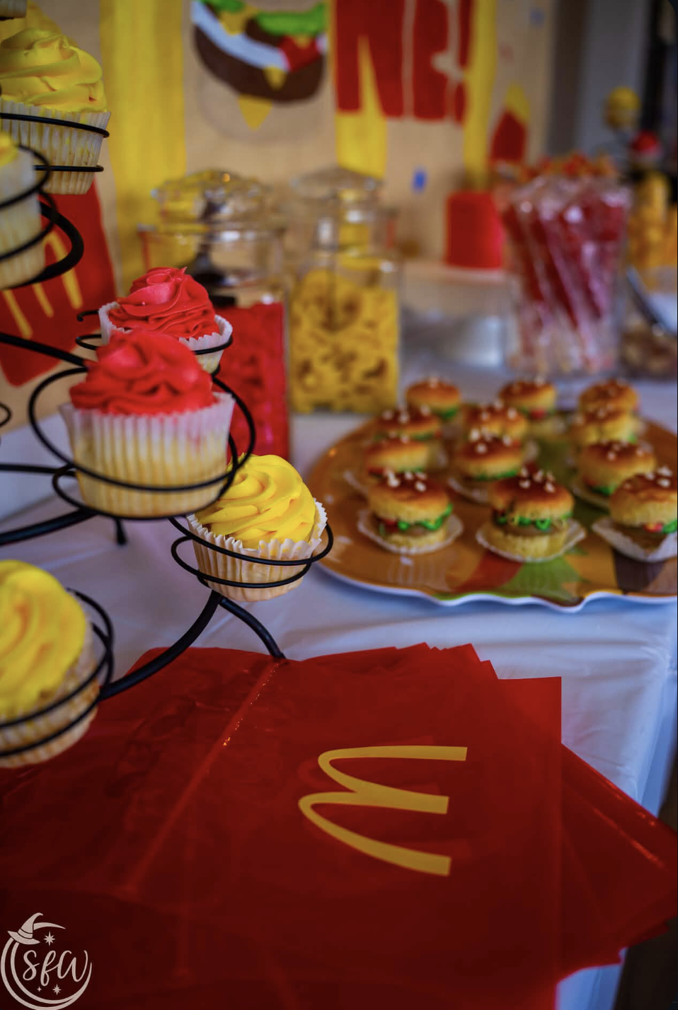 Cupcake tower and mini burger sliders styled on a celebration table